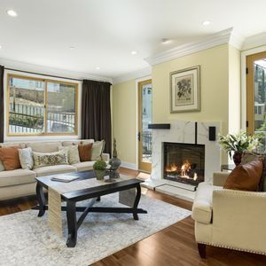 A living room filled with furniture and a fireplace.