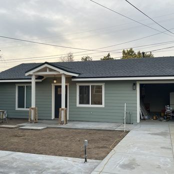 A small house with a porch and a garage