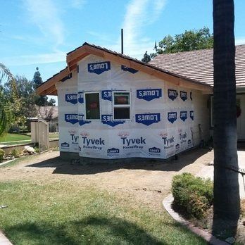 A house is being remodeled with tyvek siding on the side