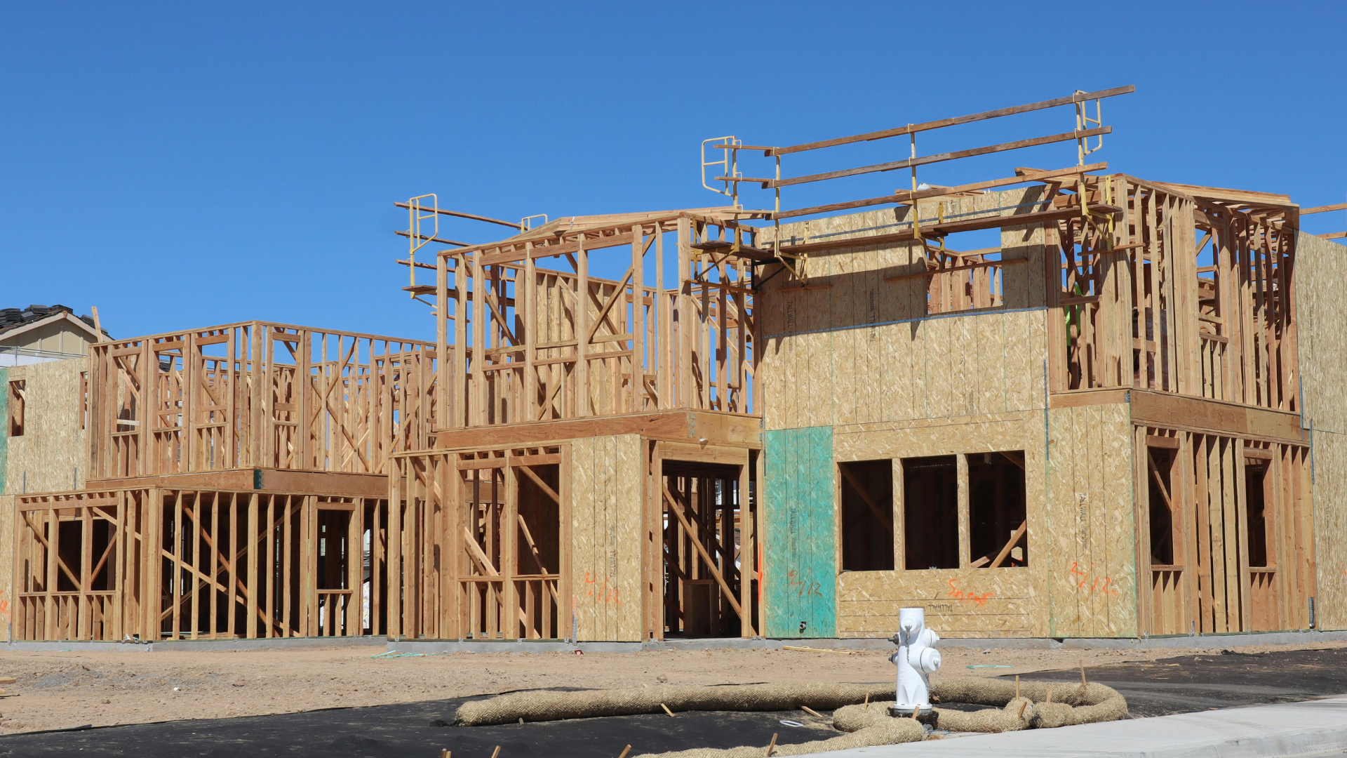A house is being built with a fire hydrant in front of it