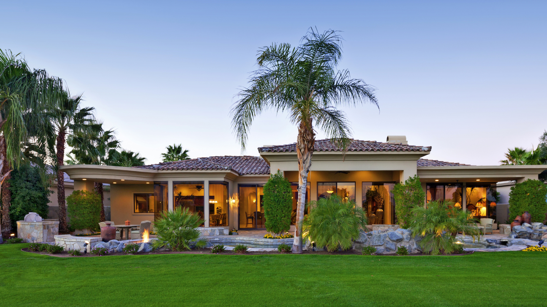 A large house with palm trees in front of it