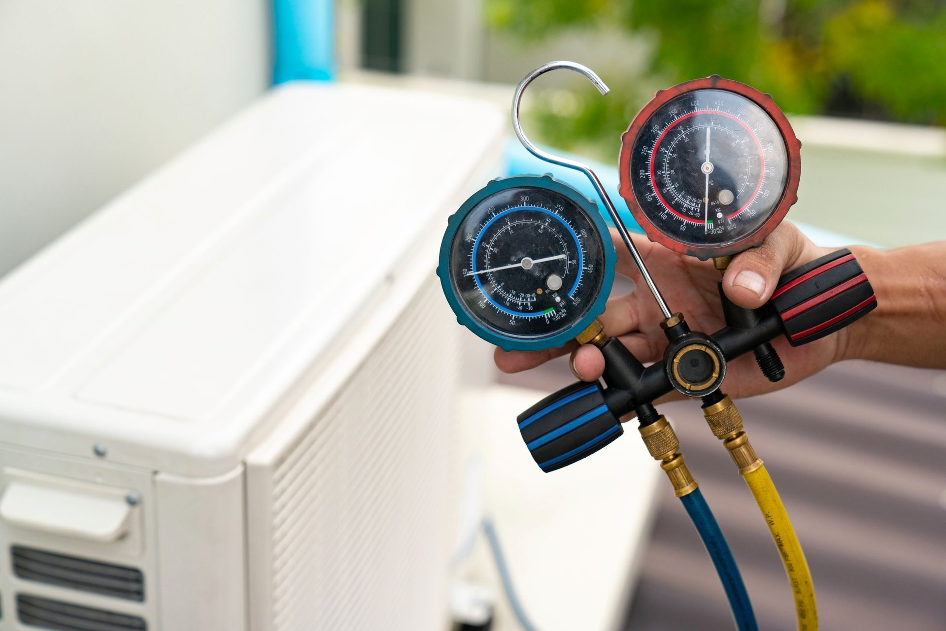 A person holding a pressure gauge