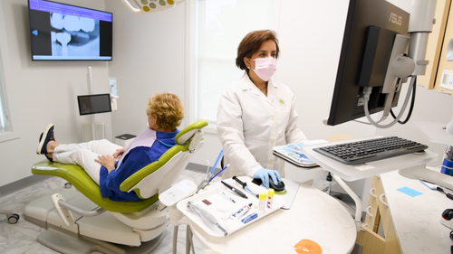 Dental X-ray with tools, color samples, and reflection mirror on a blue surface.