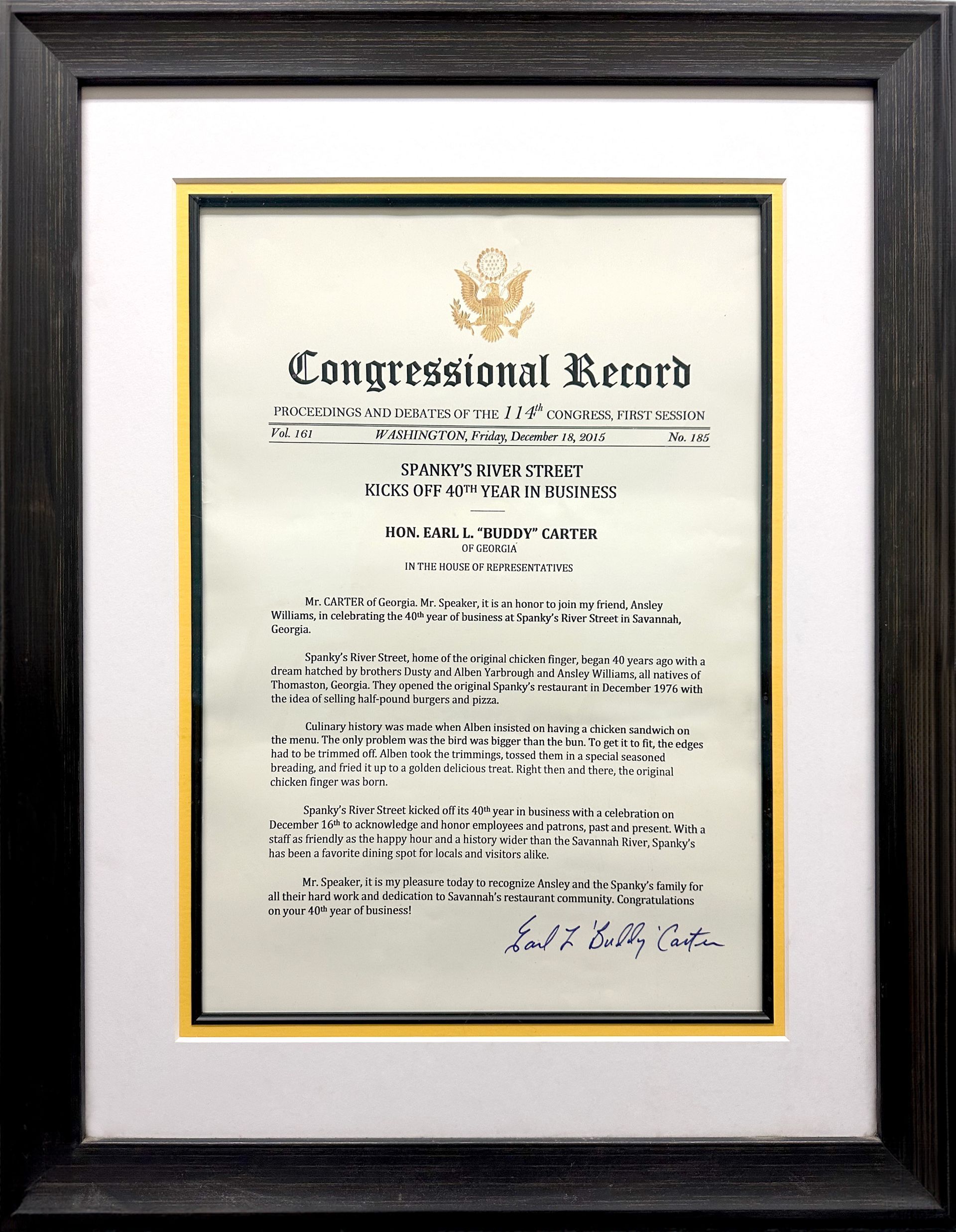 A congressional record is framed in a black frame