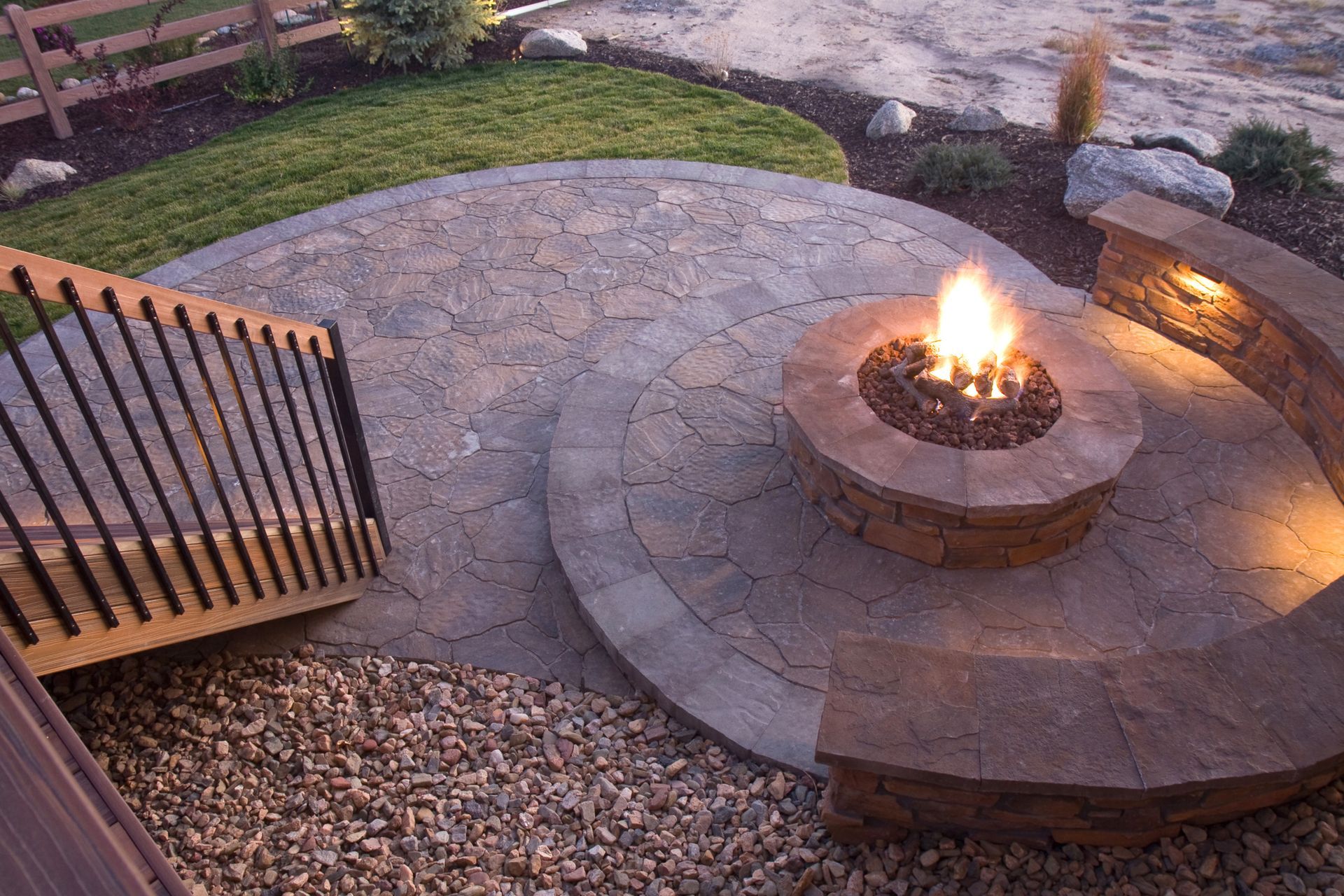 an image of a multi level stamped concrete patio with a fire pit