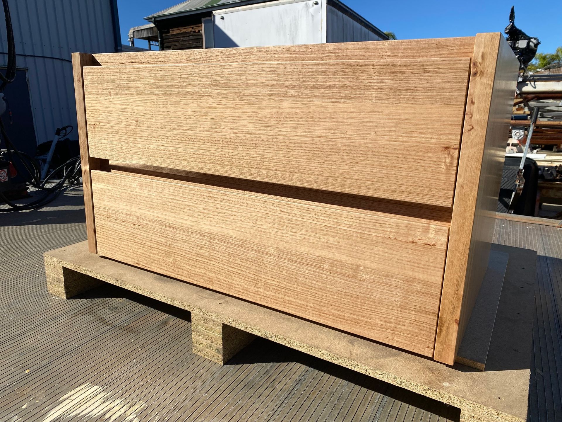 Wooden Cabinet on A Pallet Outside, Showing Wood Grain — Lukas Joinery in Cessnock, NSW