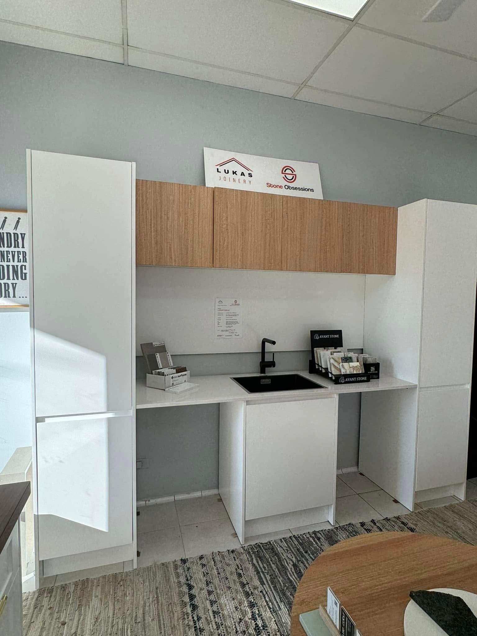 Modern Accessible Kitchen Display with White Cabinets — Lukas Joinery in Belmont, NSW