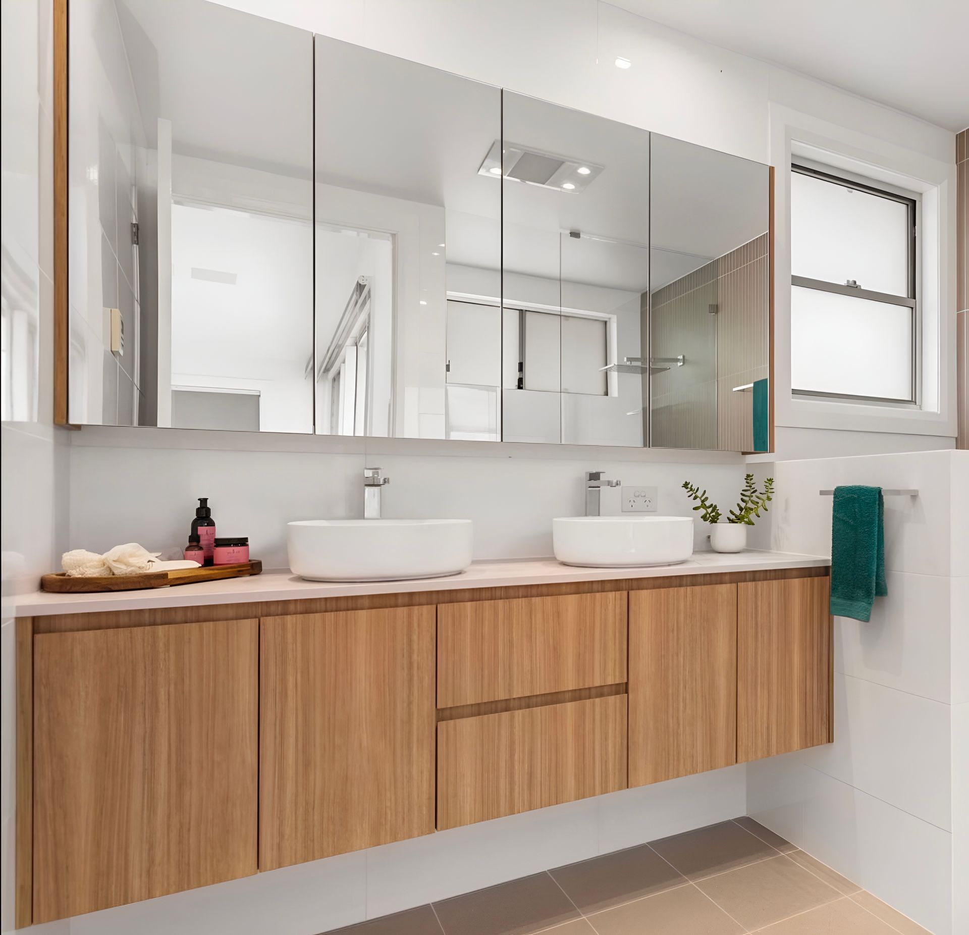 Modern bathroom with double sink, wooden vanity, large mirror, and window — Lukas Joinery in Belmont, NSW