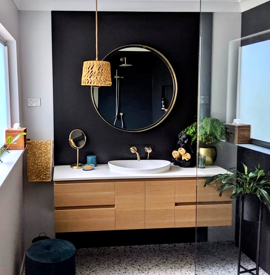 Man Installing Kitchen Cabinets in A White Kitchen  — Lukas Joinery in Belmont, NSW