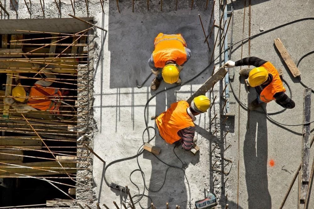 A group of construction workers are working on a construction site