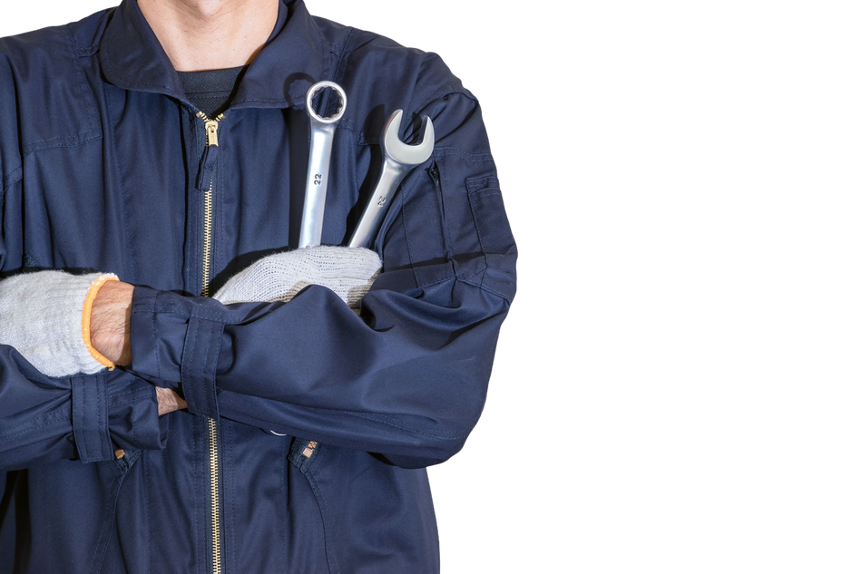 A man in a blue jacket is holding two wrenches in his hands.