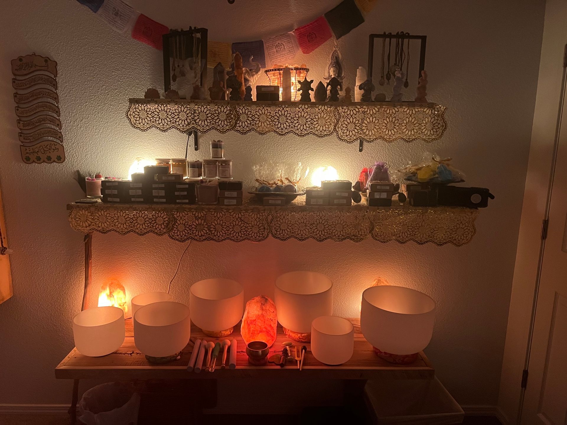 
“Sound bath and chakra healing tools including singing bowls, crystals, and gentle candlelight.”