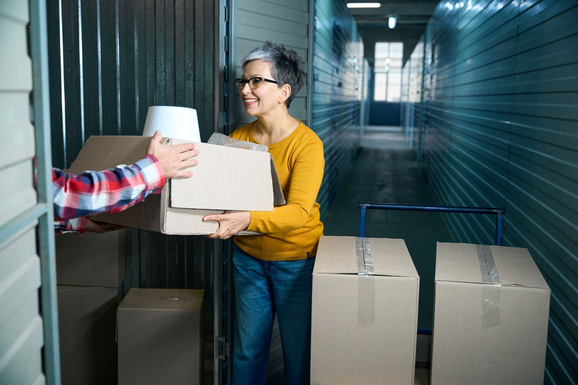 A woman moving boxes into a self-storage unit in Berwick, PA.