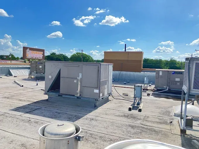 Two Yellow Jacket gauges, blue/red, connected to a heat pump, showing pressure readings.