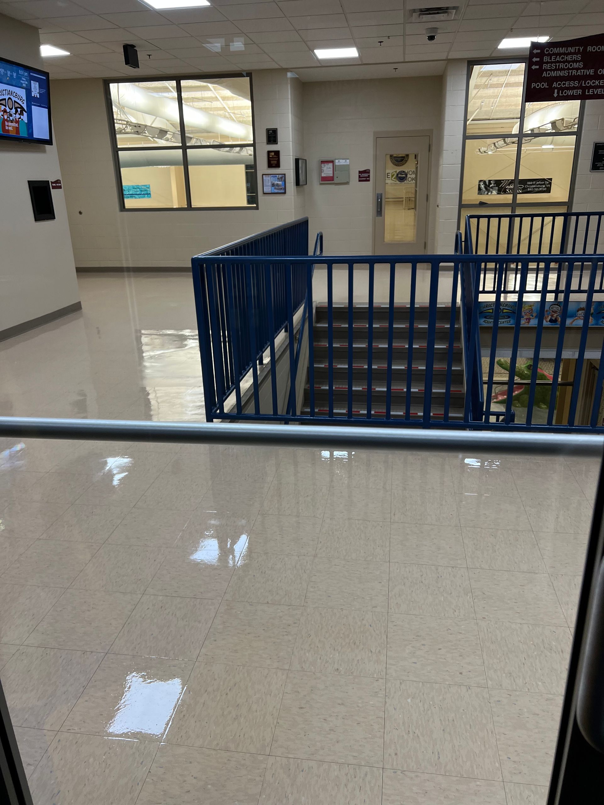 A staircase with a blue railing in a building.