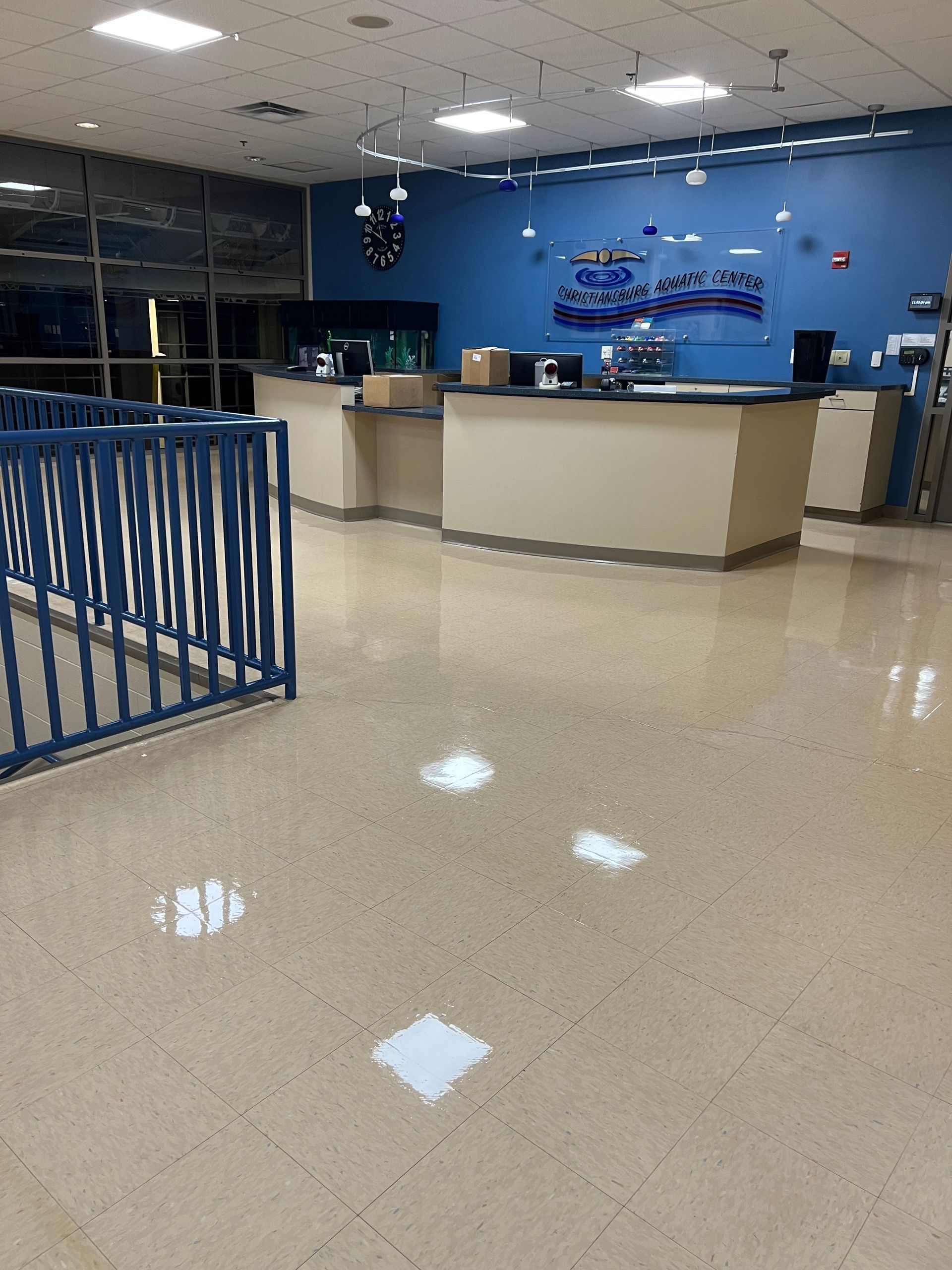 The inside of a building with a blue wall and a blue railing.