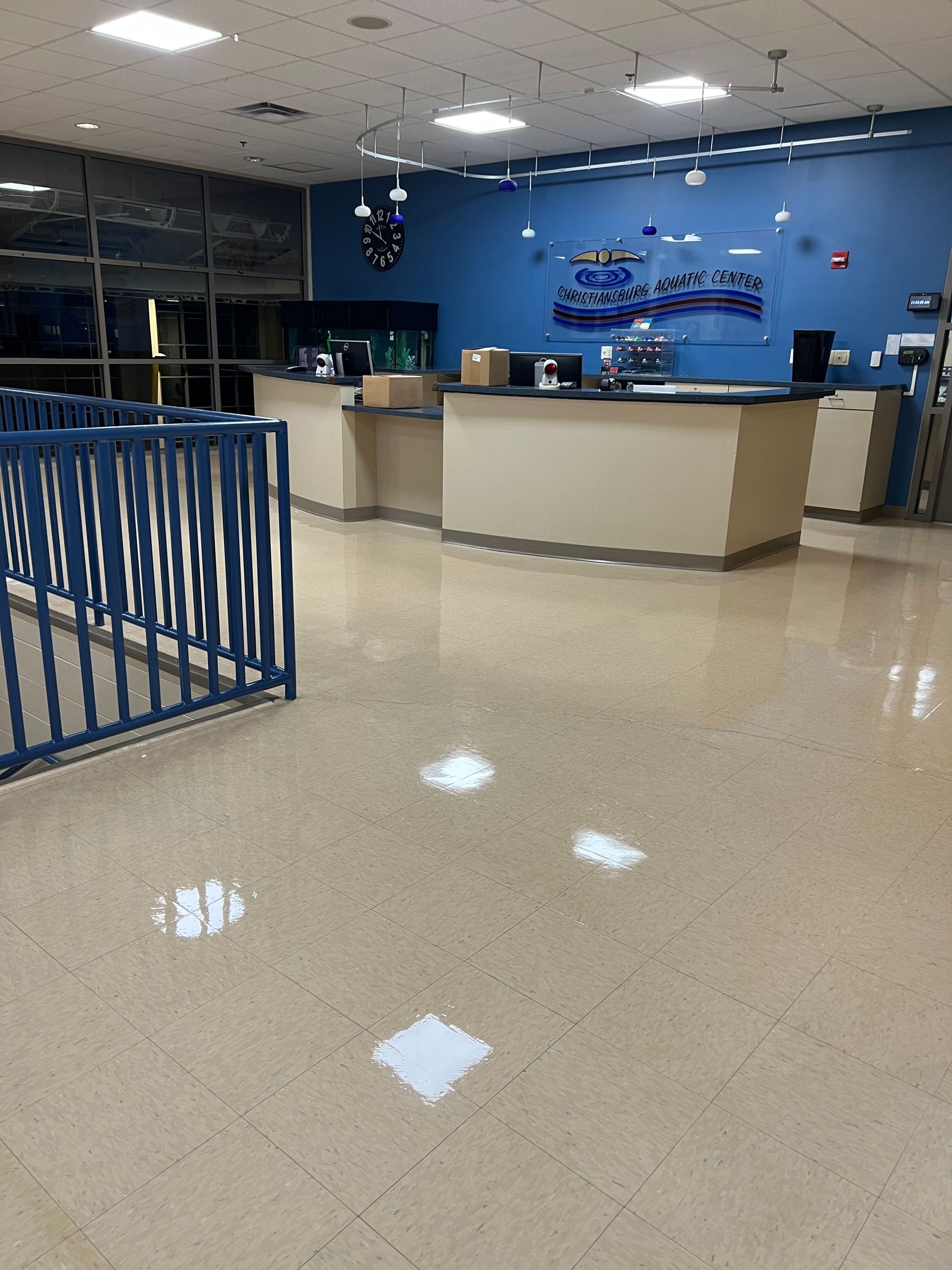 The inside of a building with a blue wall and a blue railing.