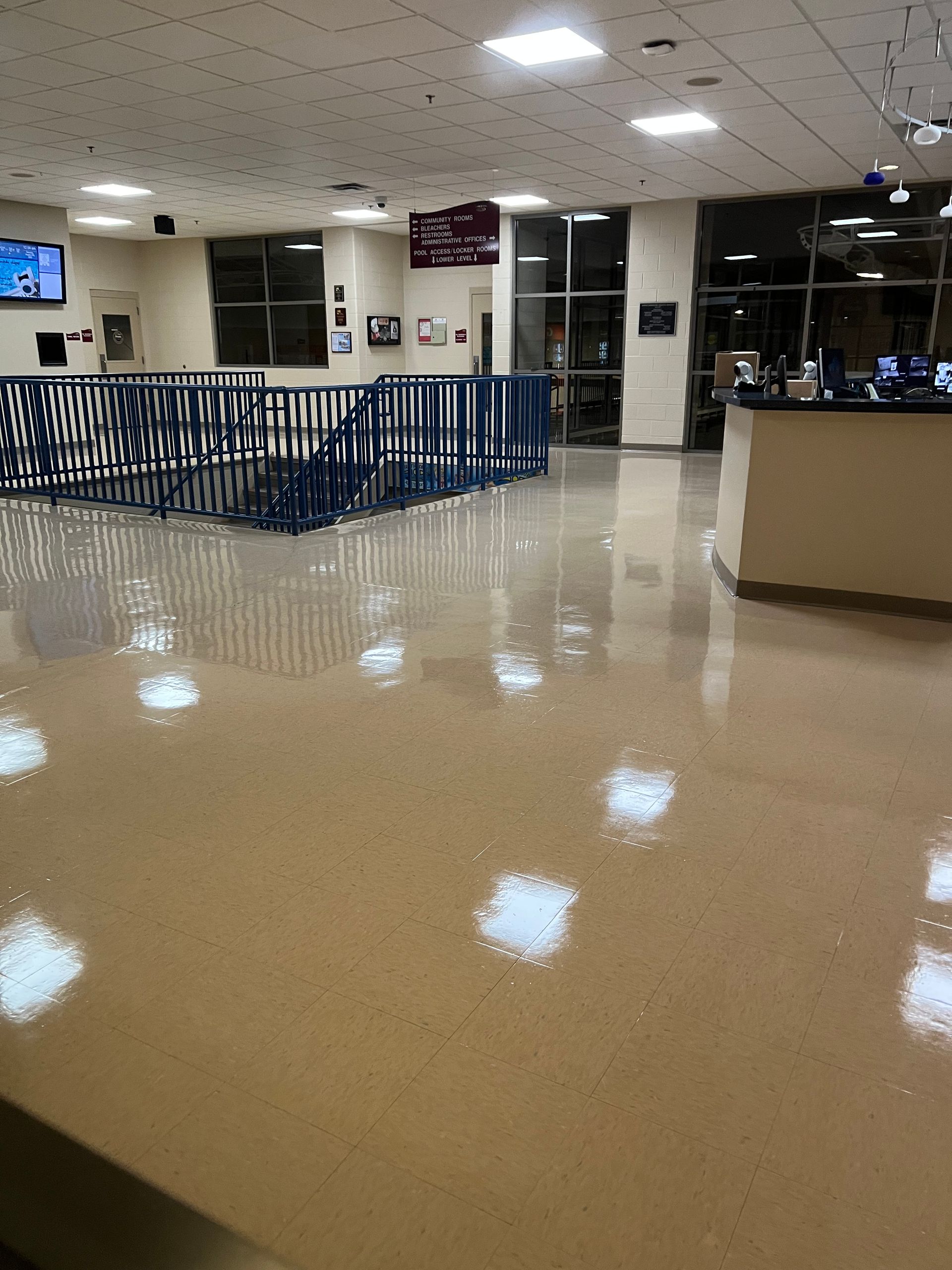 A large room with a staircase and a counter.