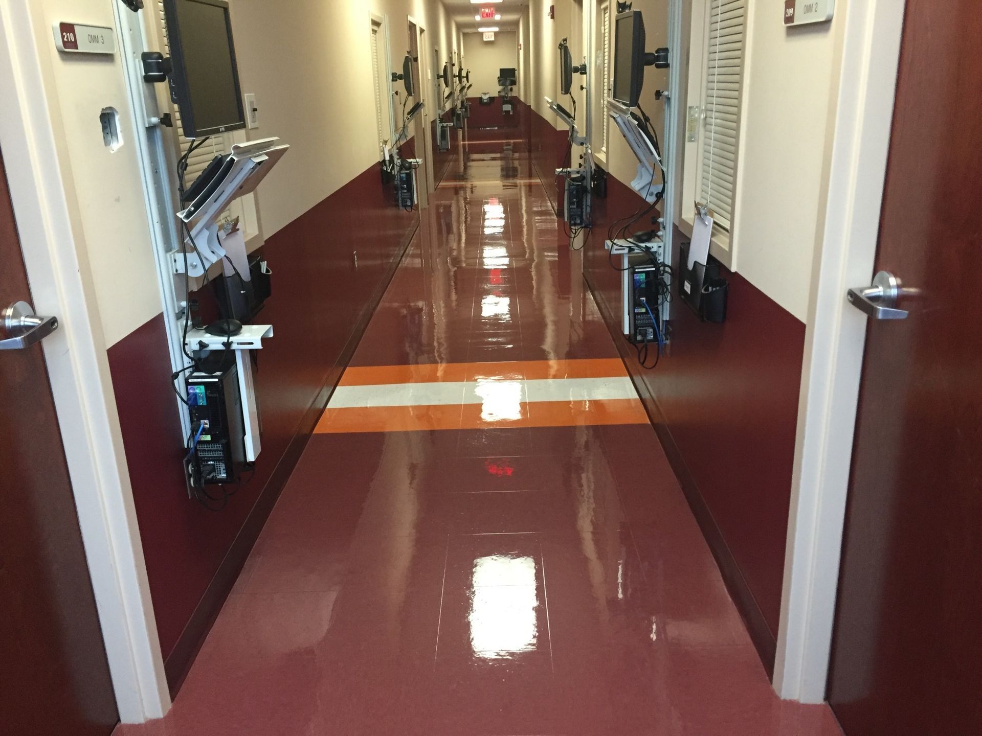 A long hallway in a hospital with a striped floor