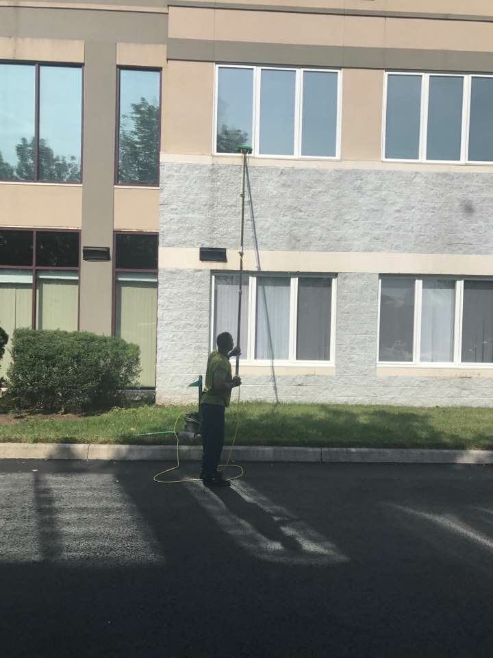 A man is cleaning the windows of a building.