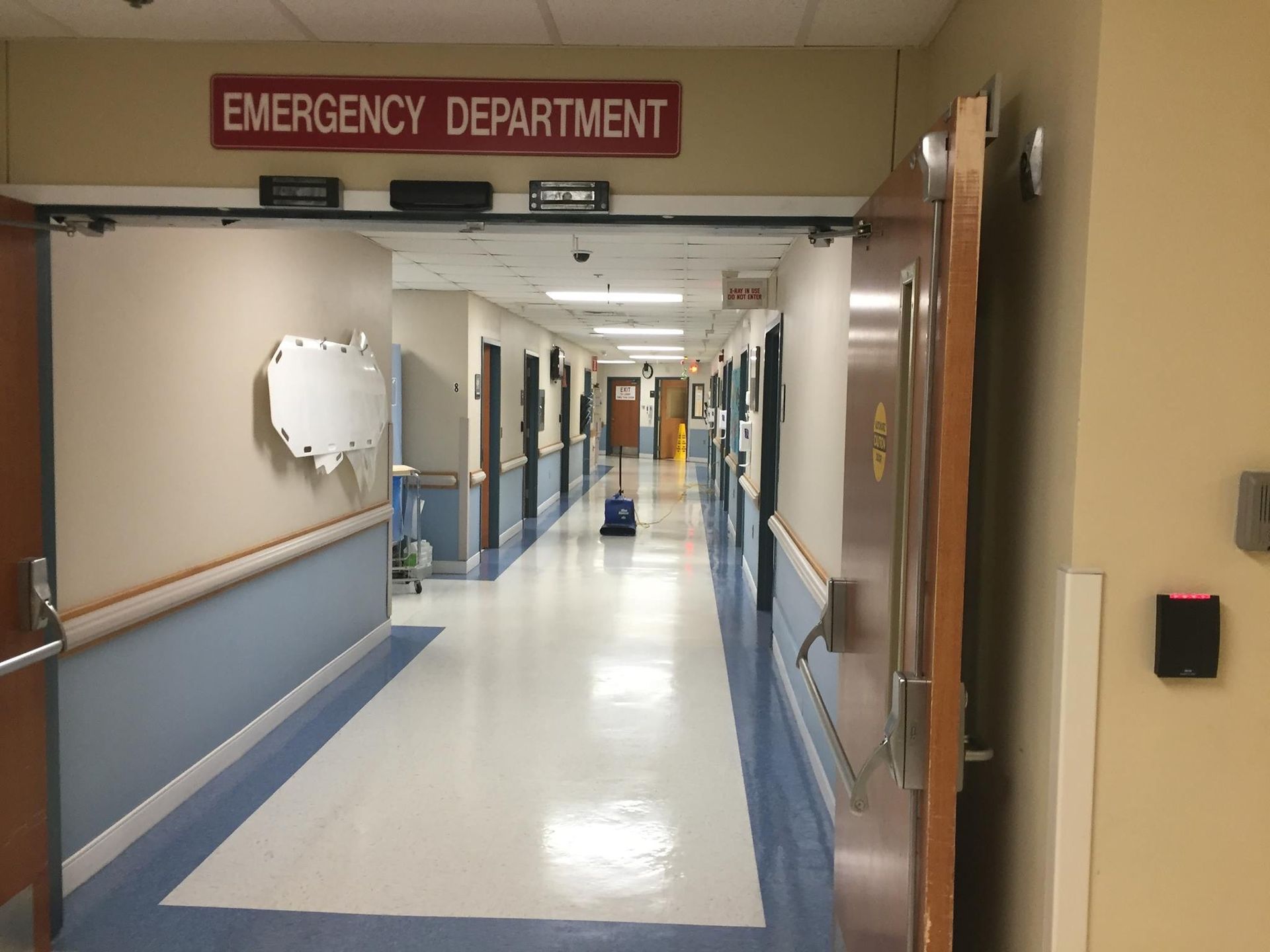 A hospital hallway leading to the emergency department.