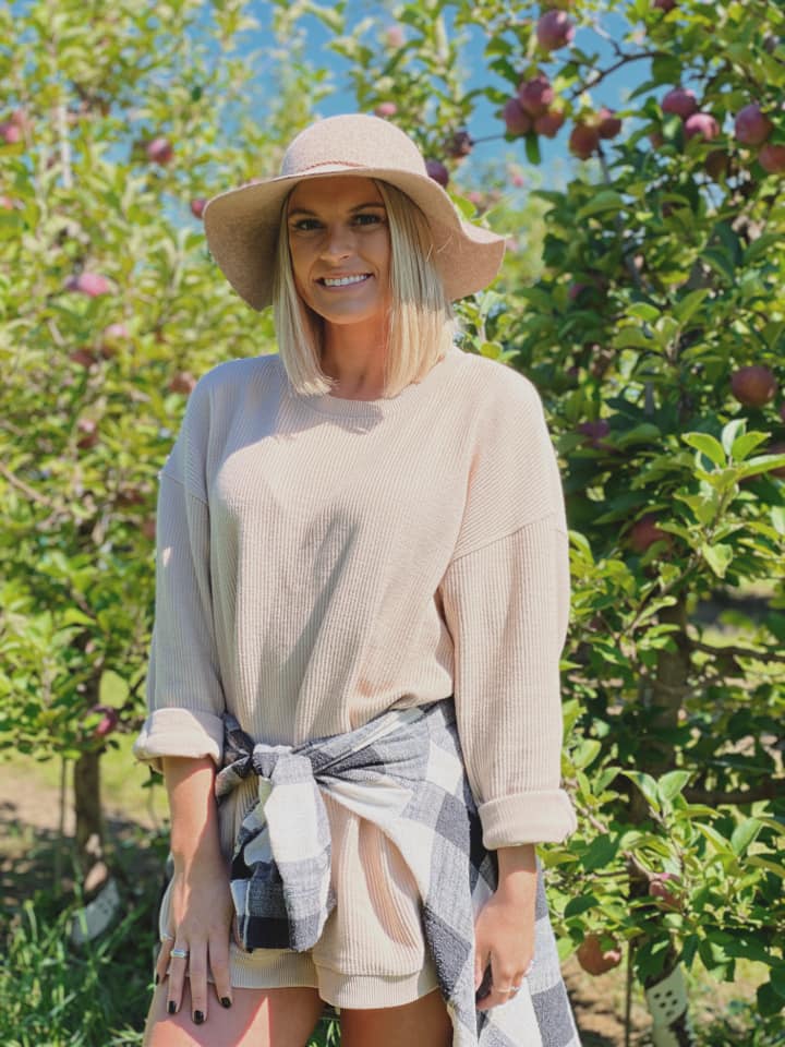A photo of a woman around apple trees — Hudsonville, MI — Hudsonville Family Dentistry