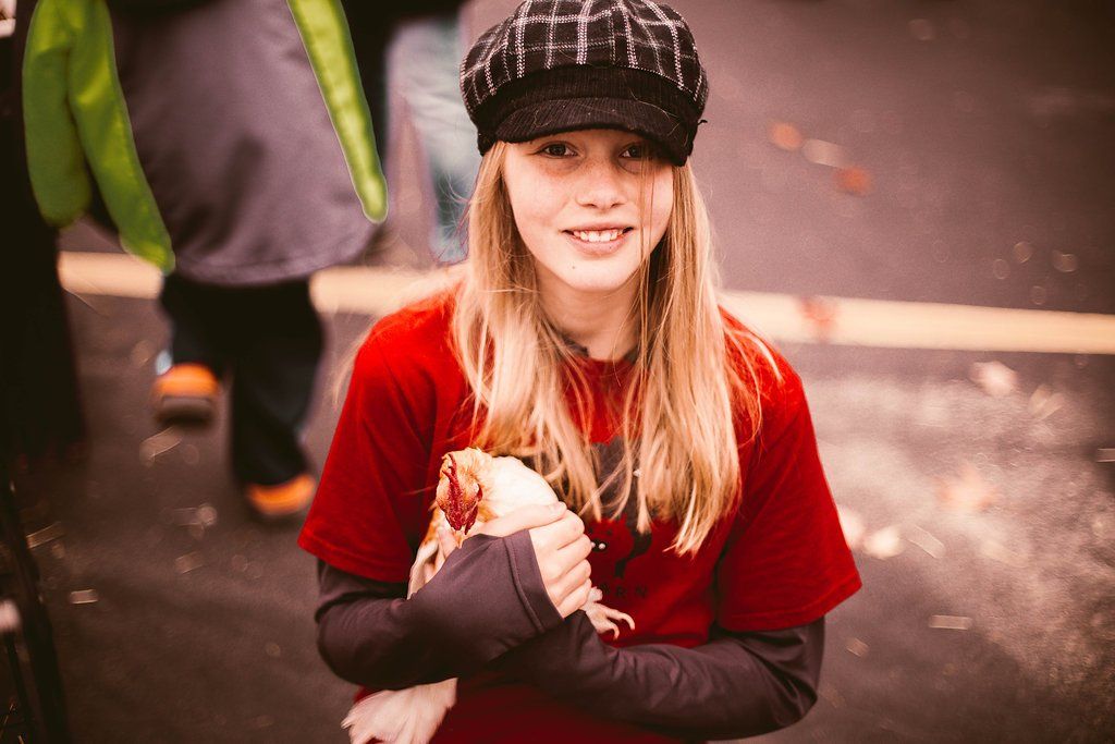Girl In Red Holding Chicken — Hudsonville, MI — Hudsonville Family Dentistry