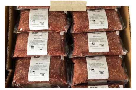 Box of vacuum-sealed ground beef packages with labels, stacked in rows inside a cardboard carton