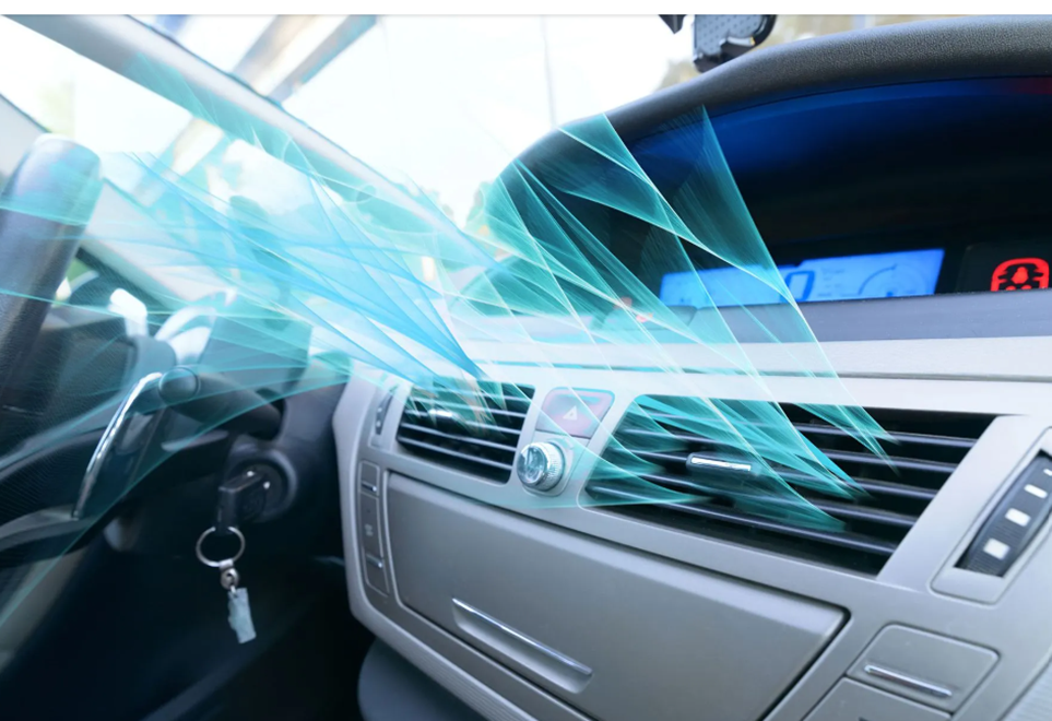 A car dashboard interior with light blue digital effects showing airflow coming from the vents. A car dashboard interior with light blue digital effects showing airflow coming from the vents.