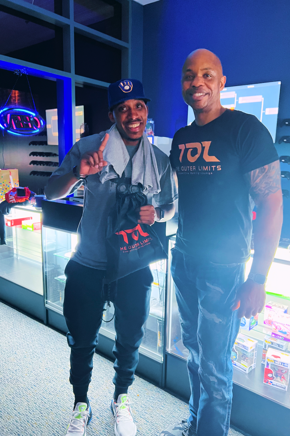 Two men are standing next to each other in a room.