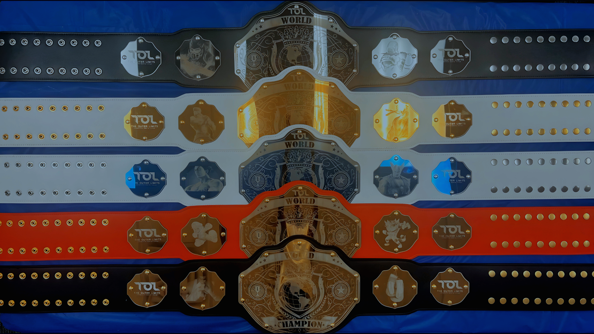 A bunch of video game tournament championship belts are lined up on a table