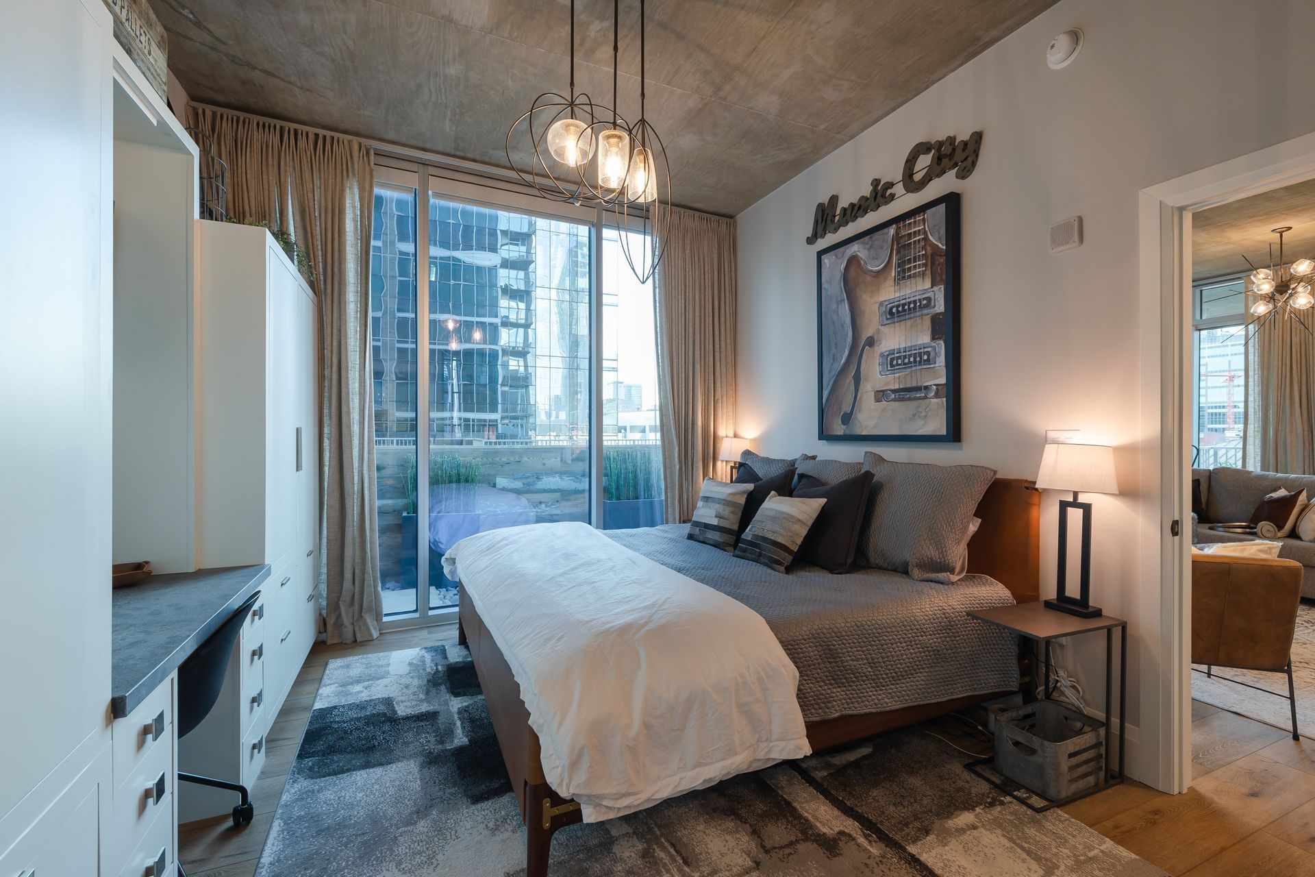 A bedroom with a large bed and a sliding glass door.