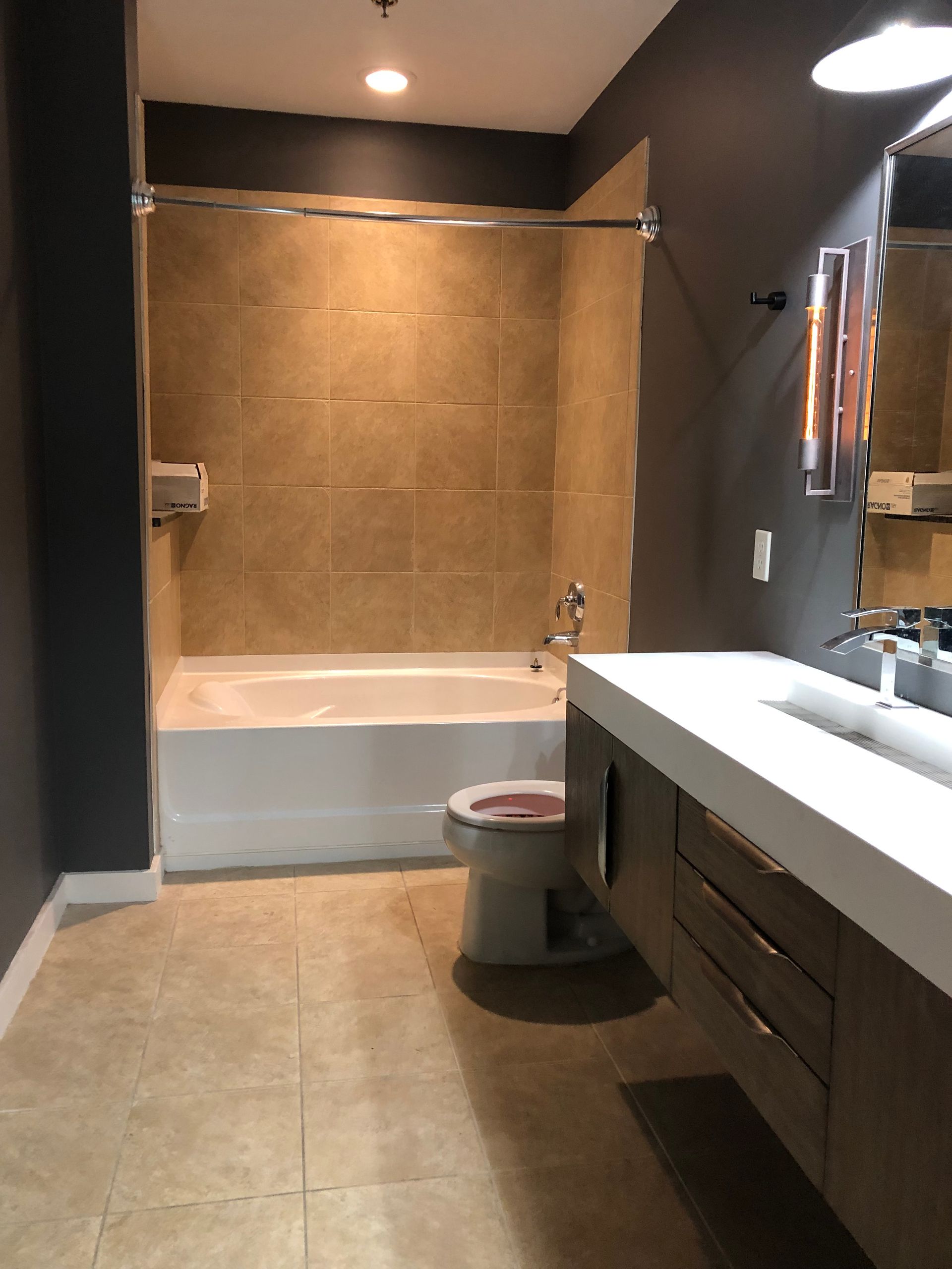 A bathroom with a toilet a sink and a bathtub