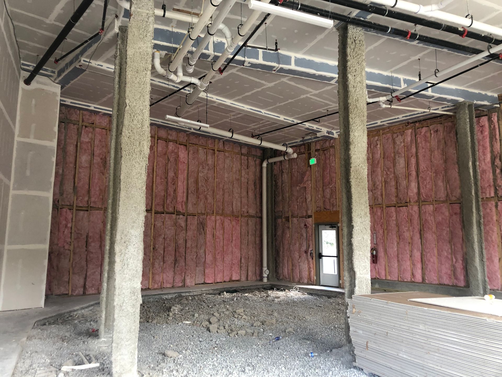 A large room with a lot of pipes hanging from the ceiling.