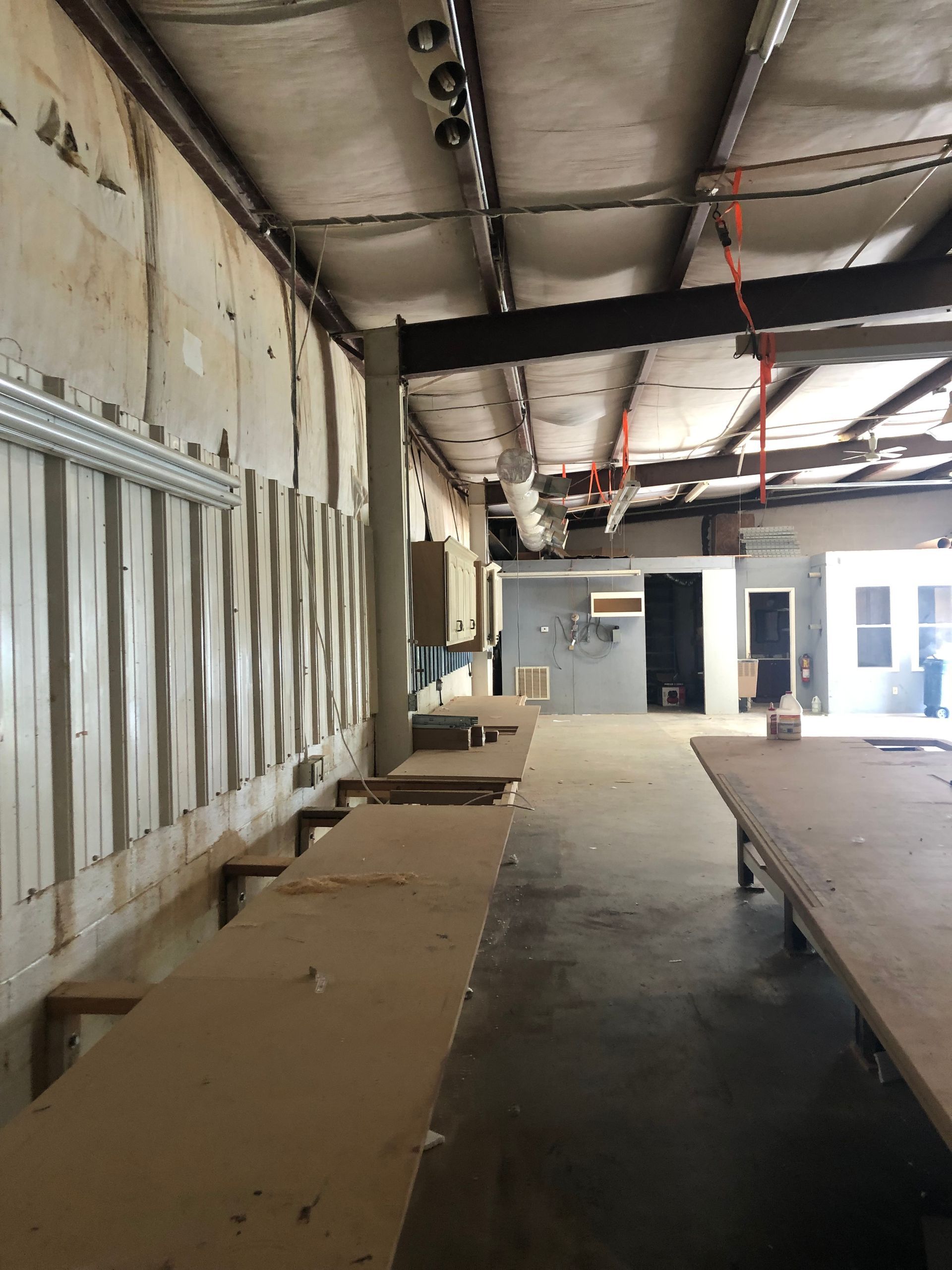 A large empty room with a lot of wooden tables