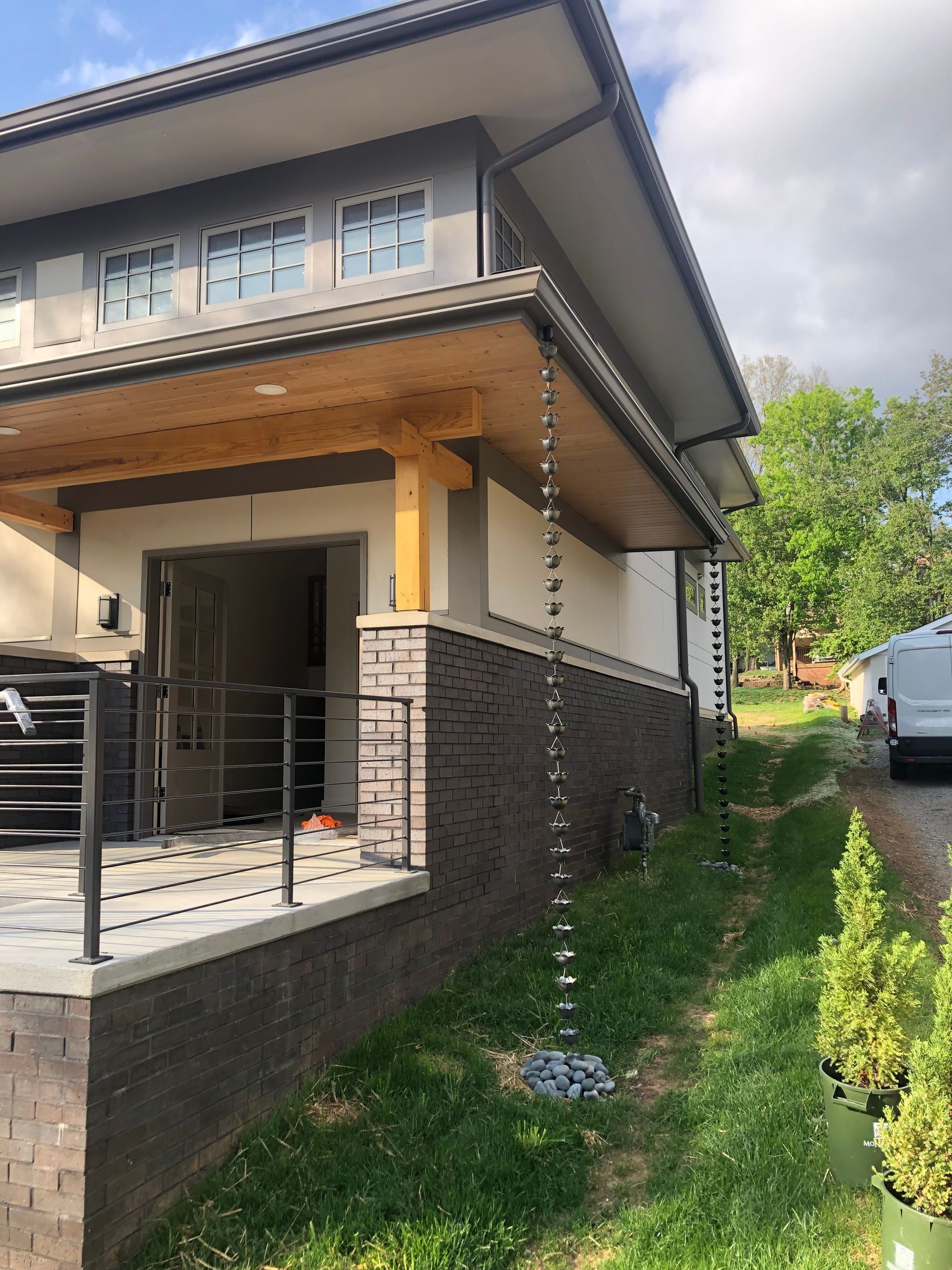 A white van is parked in front of a house