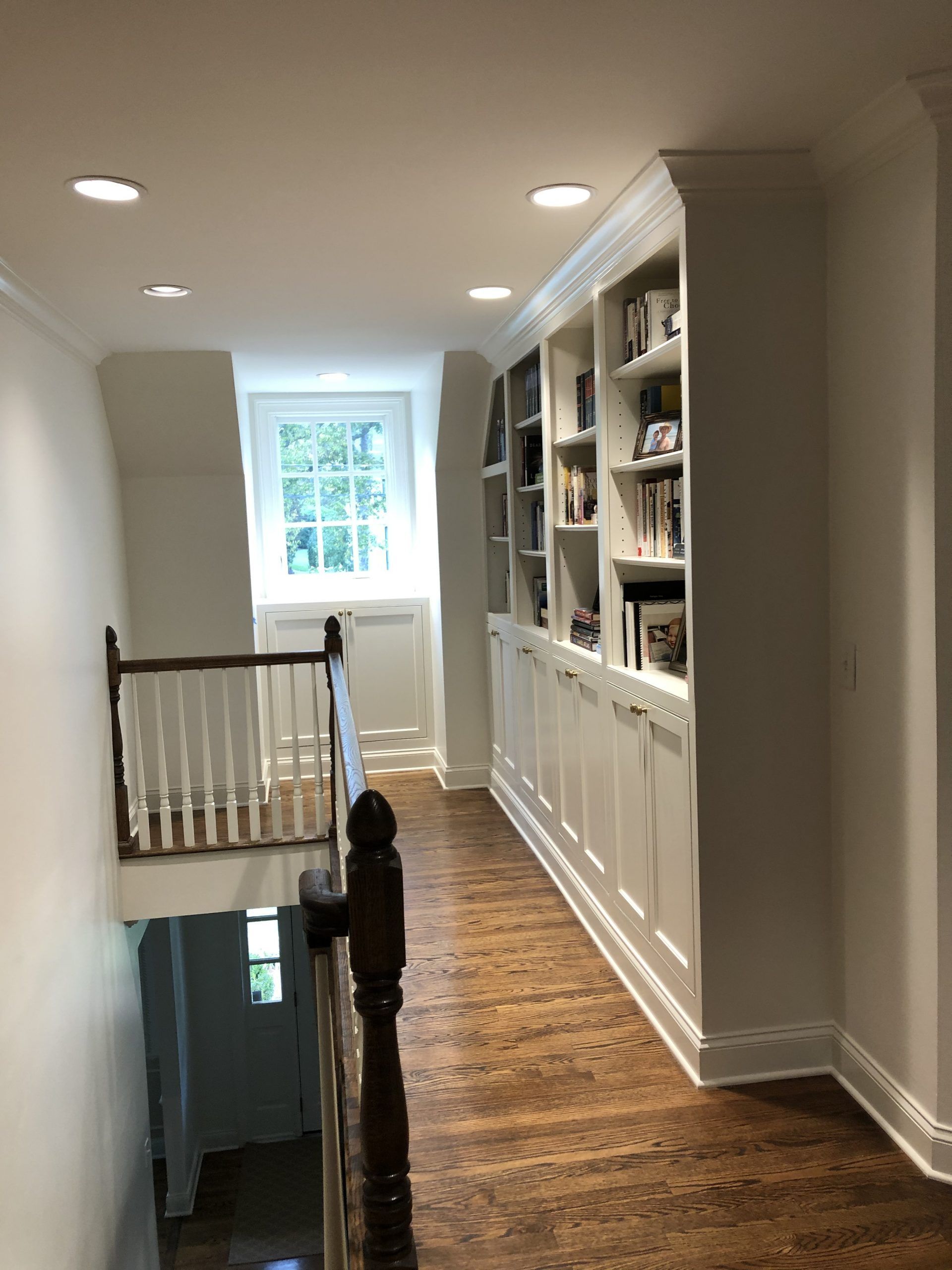 A hallway with a staircase leading up to the second floor.