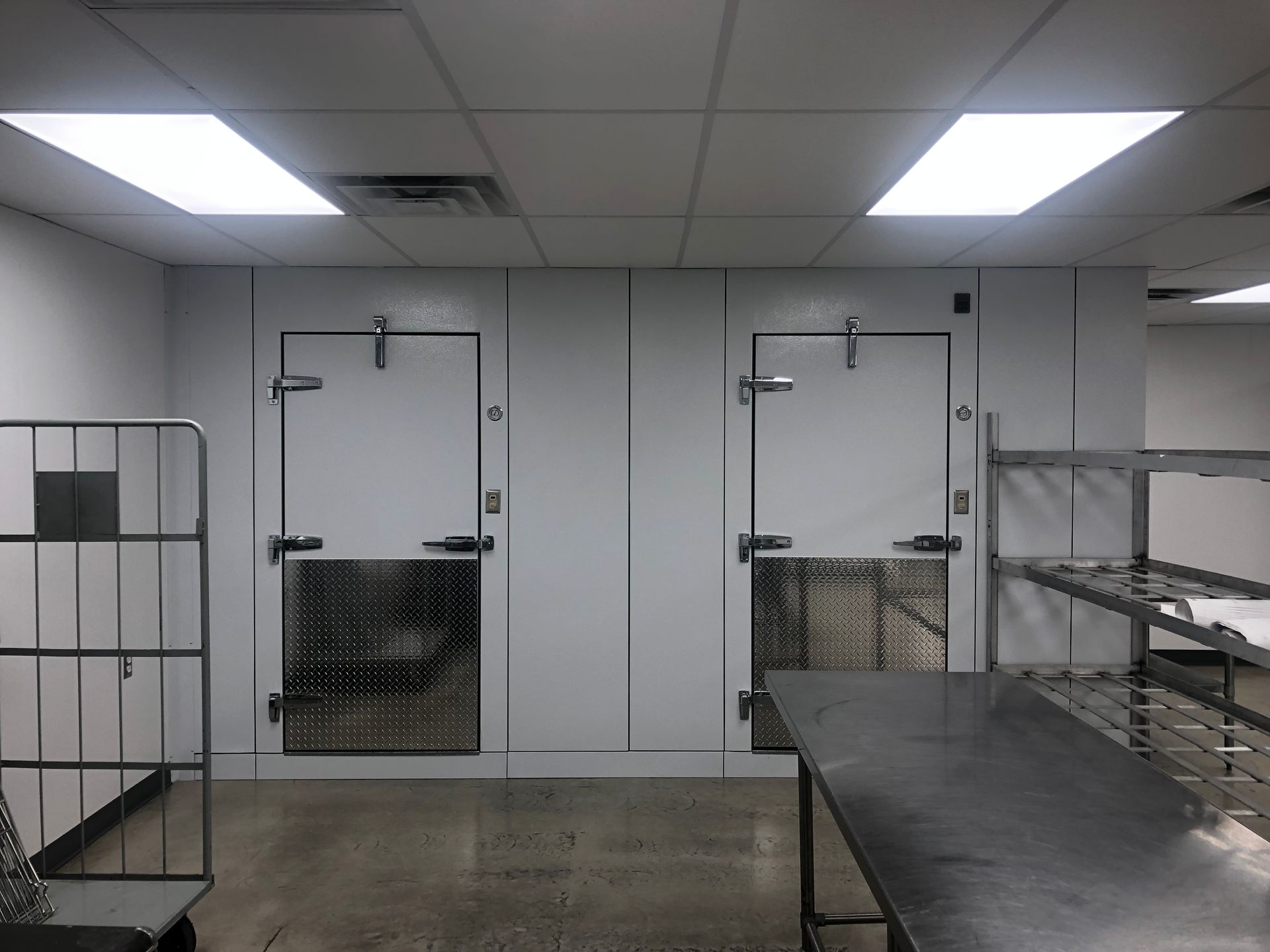 A room with two doors and a table in it