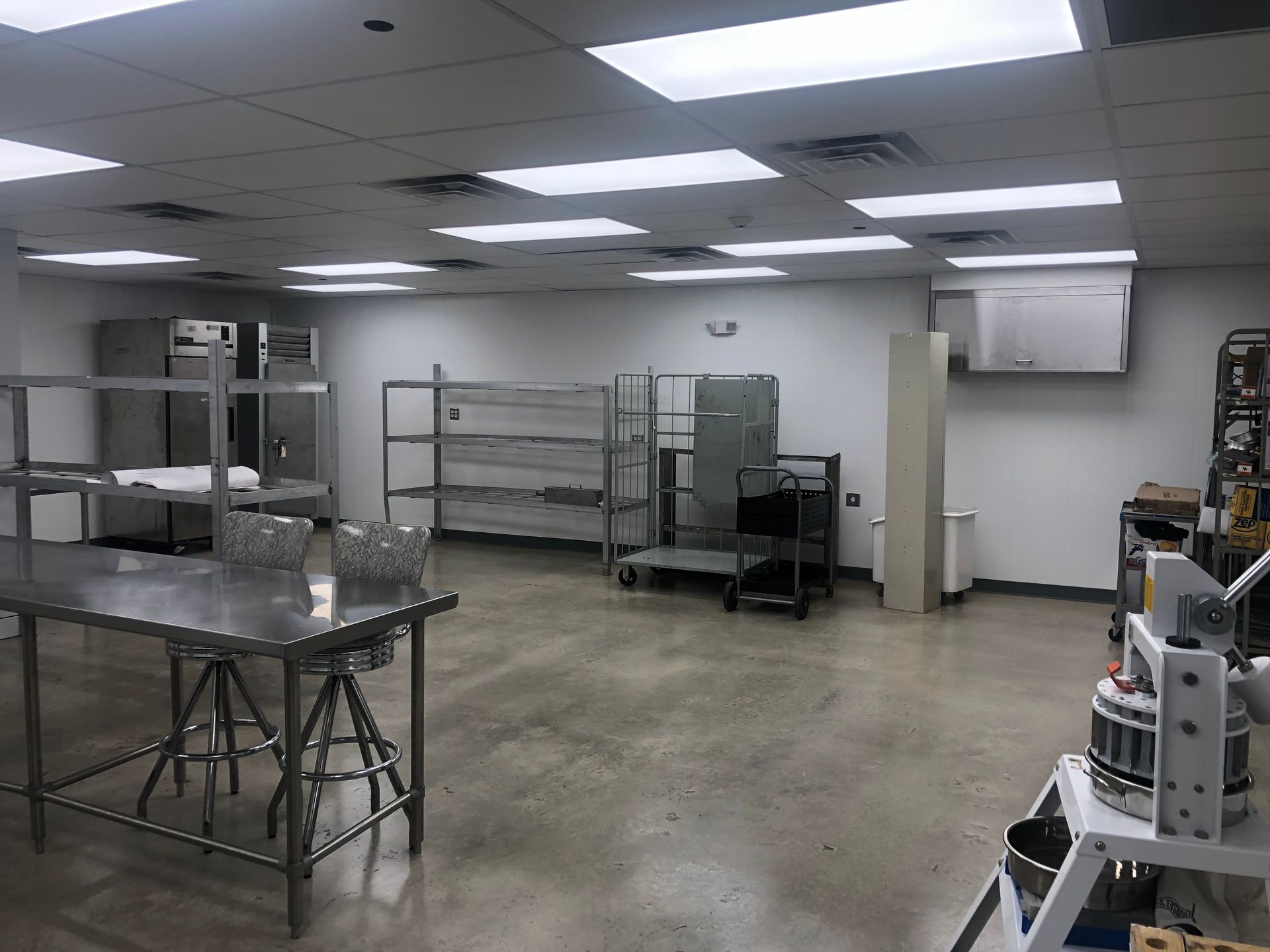 A large room with a table and chairs in it