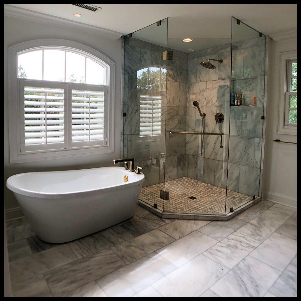 A bathroom with a bathtub and a walk in shower