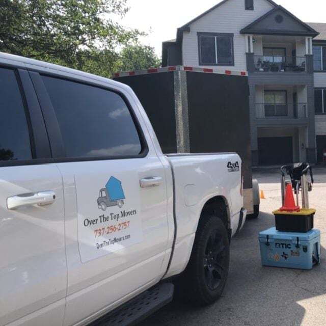 A white truck with over the top moving written on the side