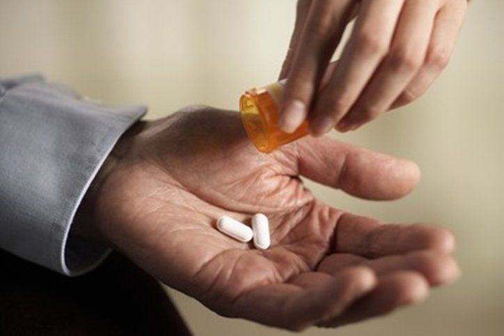 Elderly Medication Help —  Giving Prescription Pills To Senior Man in Marco Island, FL