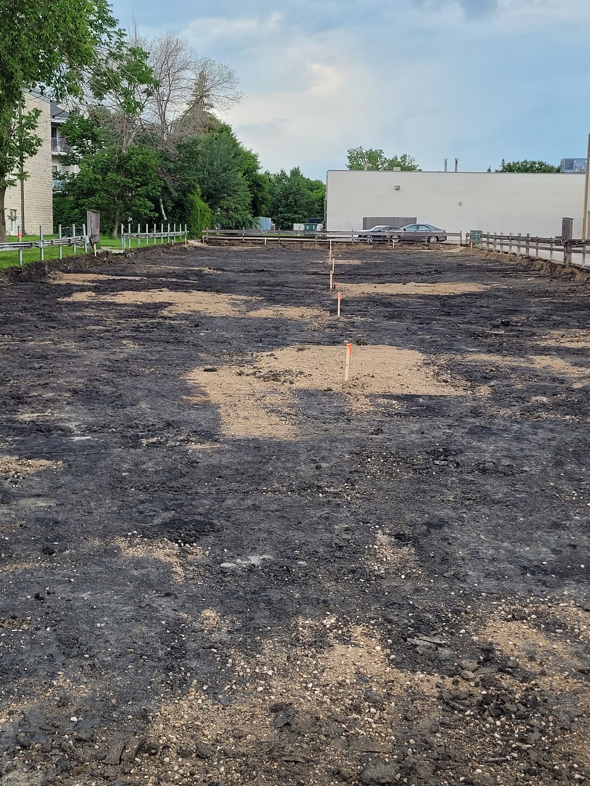 A construction site with a lot of dirt and a bulldozer in the background.