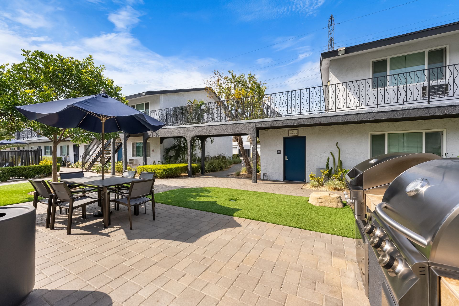 BBQ grills, picnic table, and umbrella