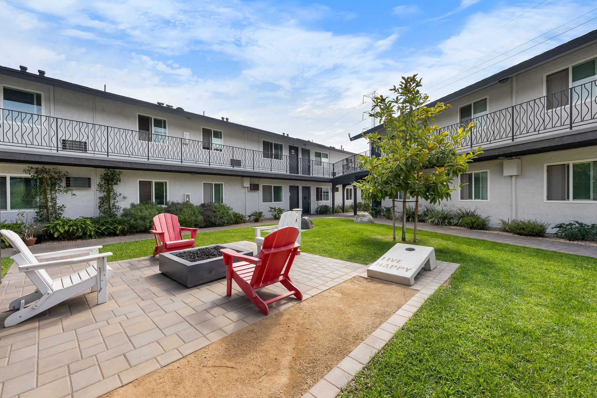 fire pit, chairs, and cornhole