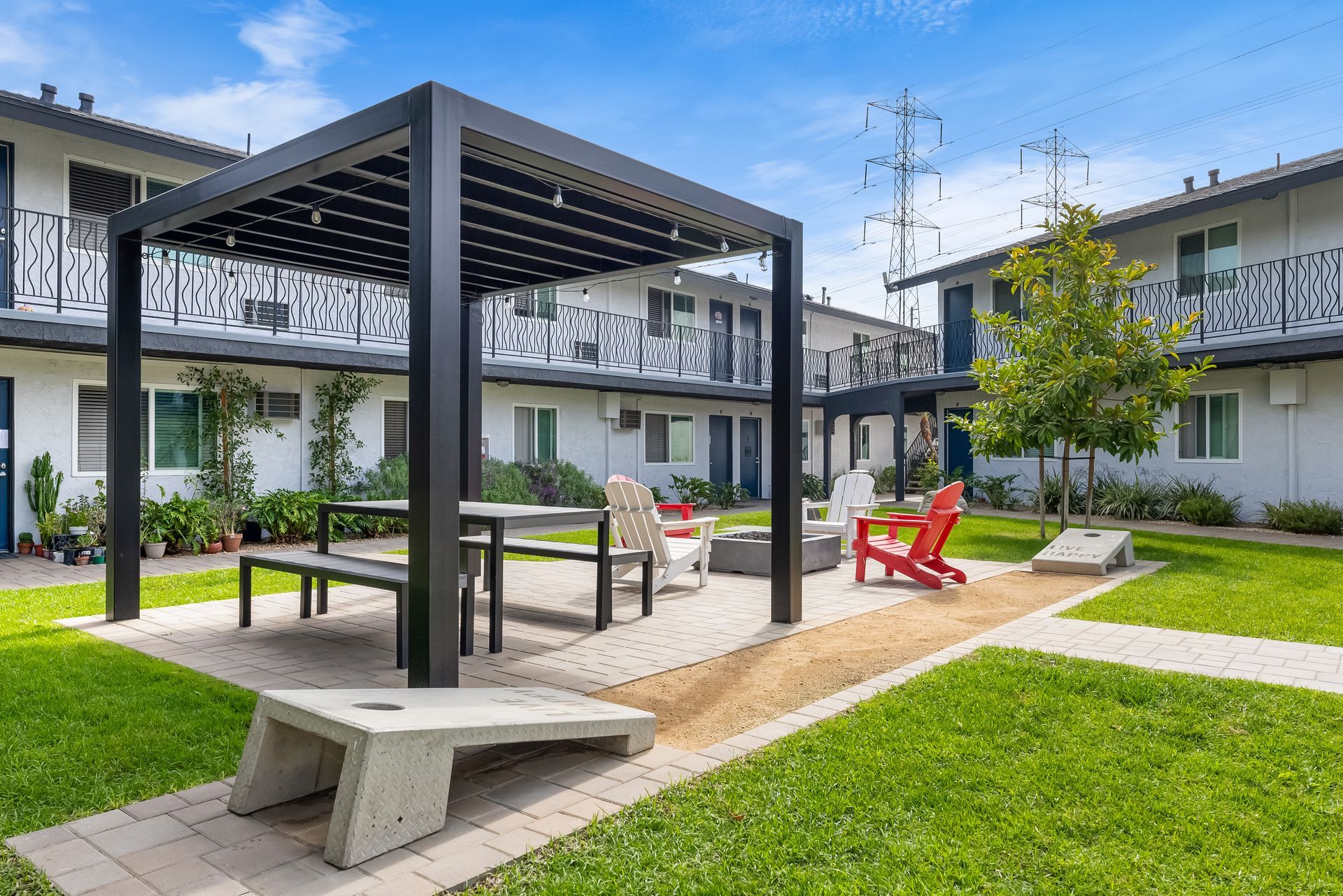gazebo, picnic table, and corhole set up