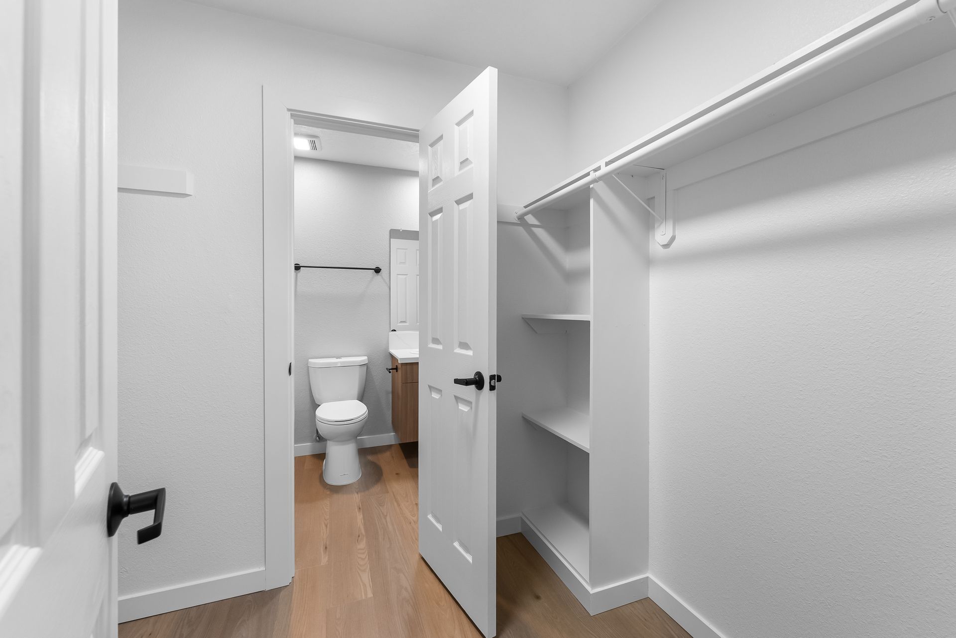 hallway with shelves and door open to bathroom