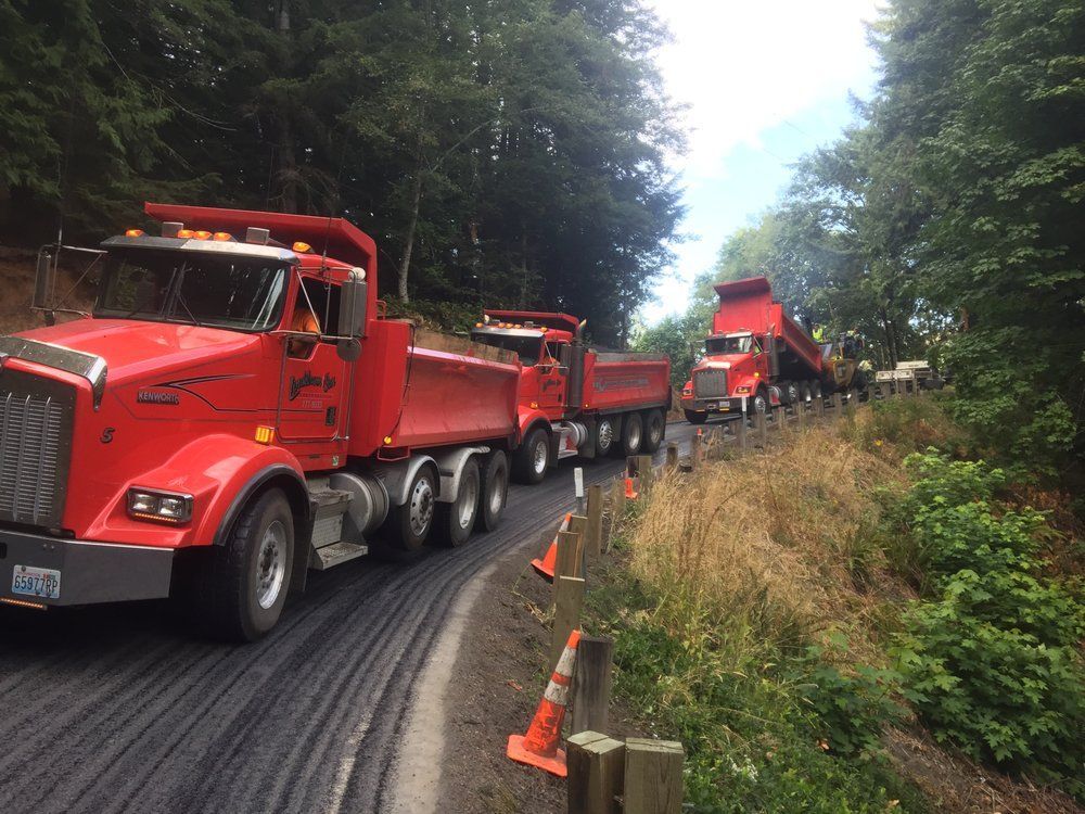A bobcat excavator is parked in a grassy field.