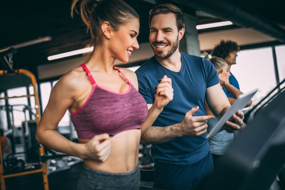 Photo of Attractive Woman Jogging on Treadmill — Functional, Strength And Conditioning Gym in Gold Coast, QLD