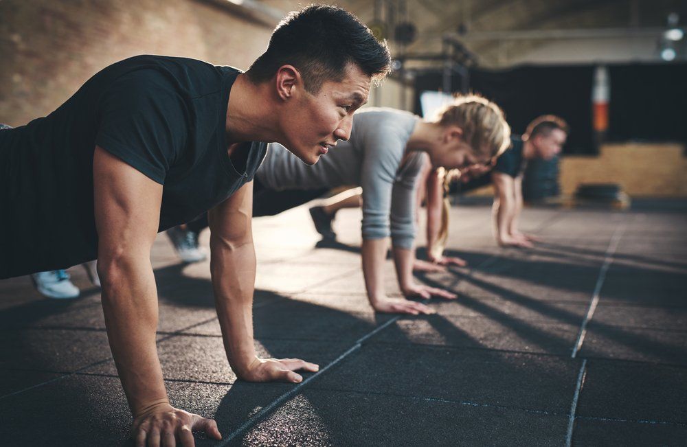 Fit Young People Doing Pushups — Functional, Strength And Conditioning Gym in Gold Coast, QLD